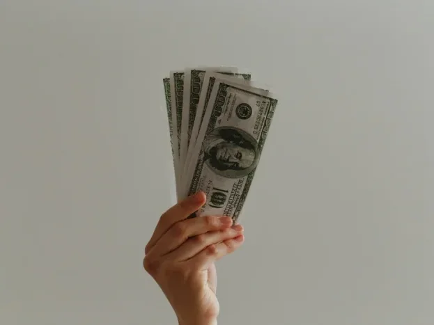 Document Signature Hand Holding Money - Asuransi Jiwa Syariah