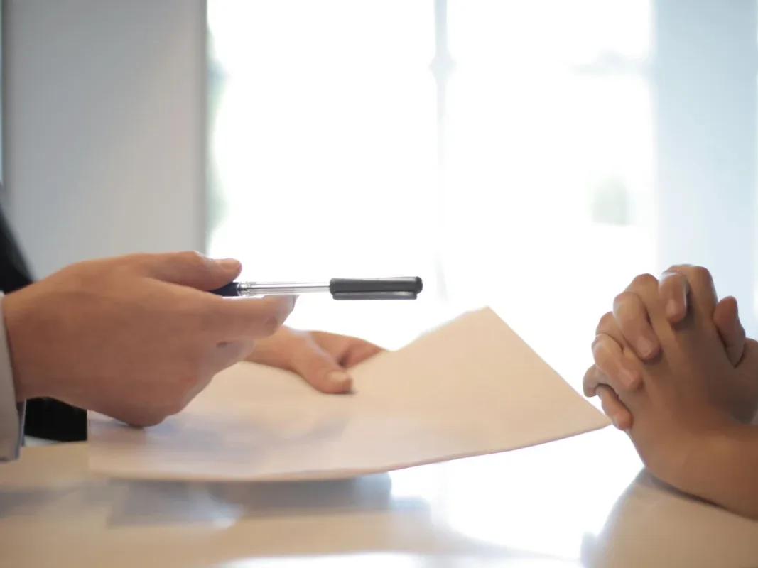 Loan Restructuring Document Hand Holding Pen - Restrukturisasi Pinjaman